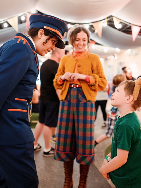 Guests interacting with staff at the Paddington Bear experience in London, a family-friendly tour.