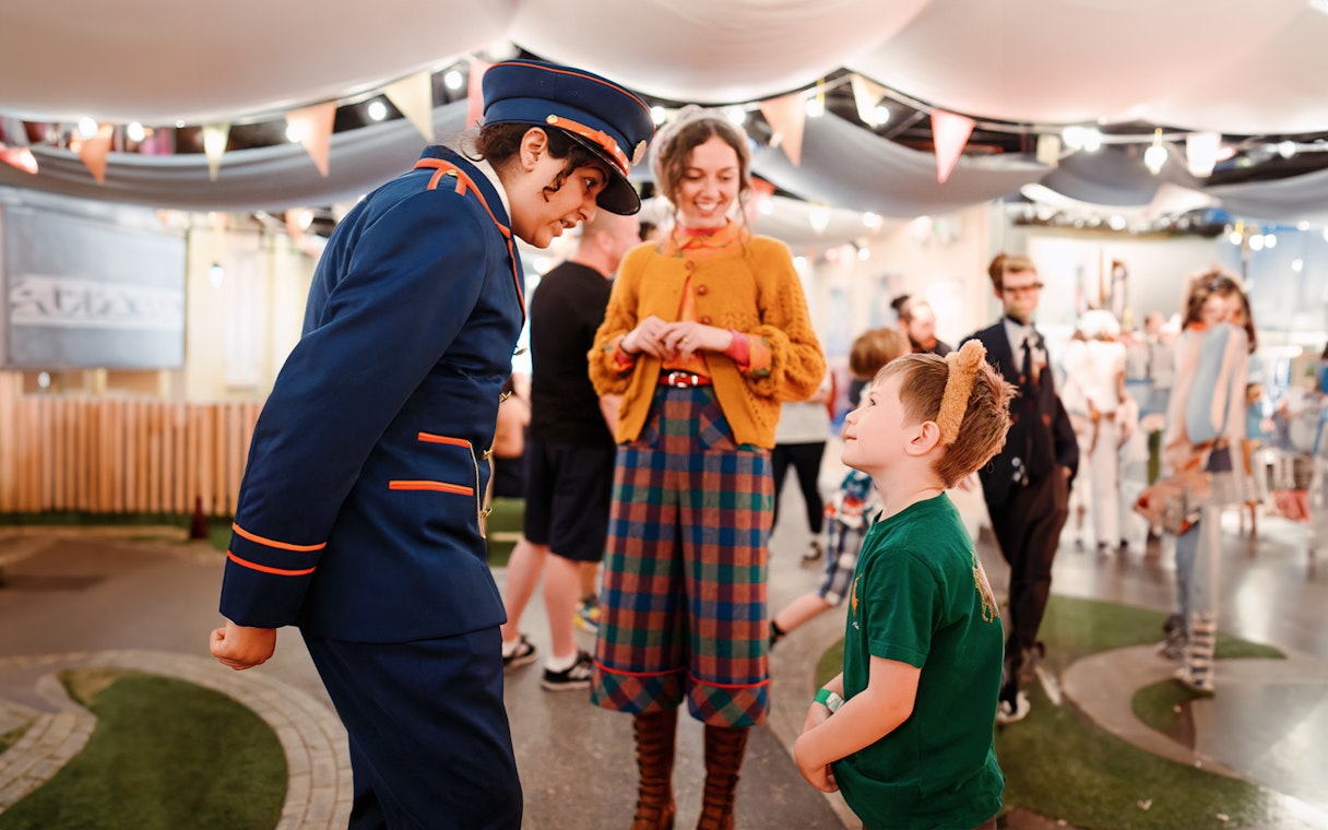 Guests interacting with staff at the Paddington Bear experience in London, a family-friendly tour.