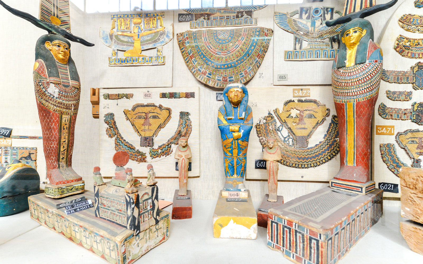 Ancient Egyptian artifacts displayed inside a museum exhibit.