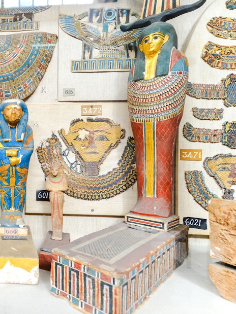 Ancient Egyptian artifacts displayed inside a museum exhibit.