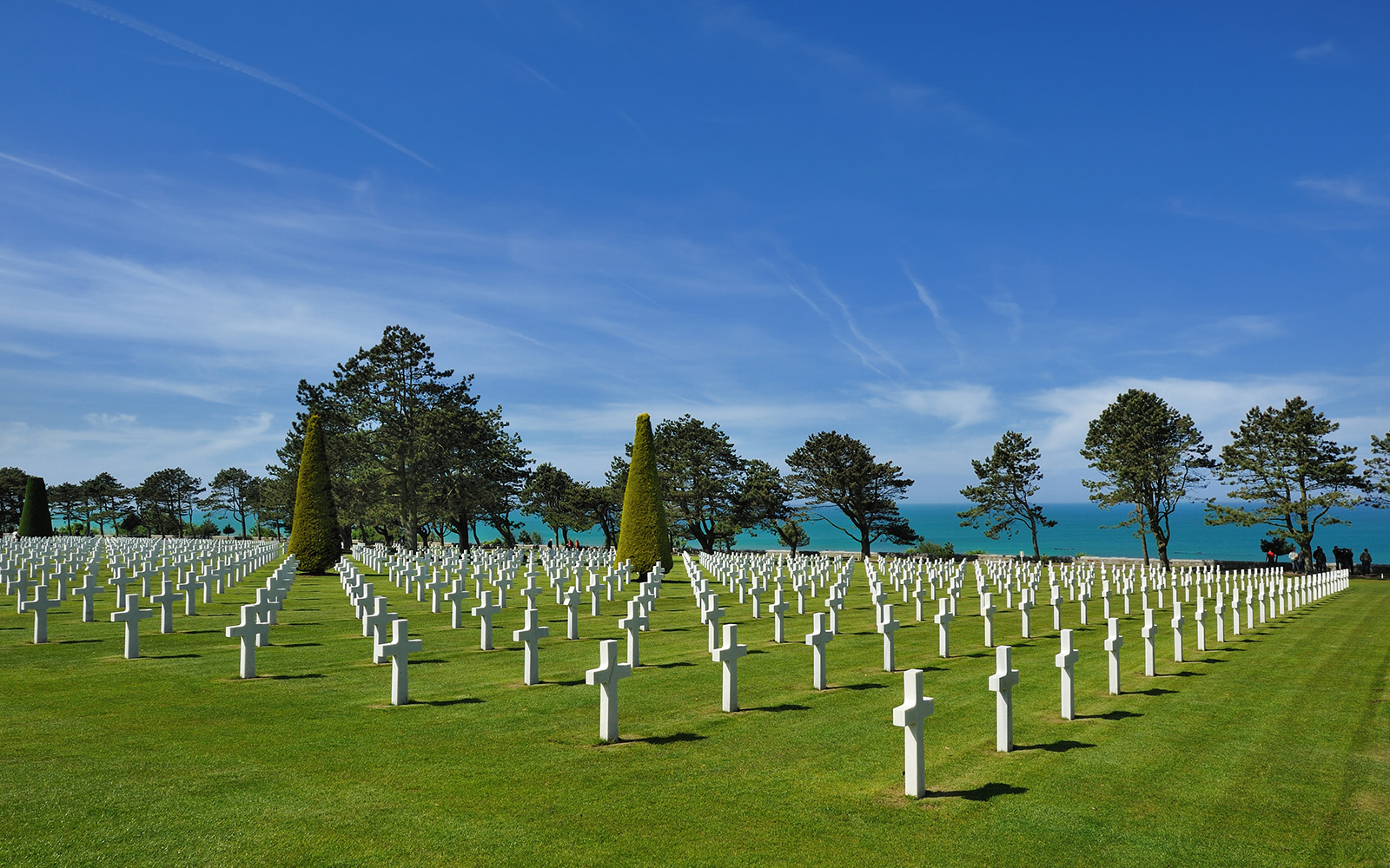 Normandy American Cemetery with rows of white crosses in Colleville-sur-Mer, France.