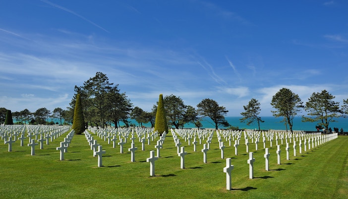 Normandy American Cemetery with rows of white crosses in Colleville-sur-Mer, France.