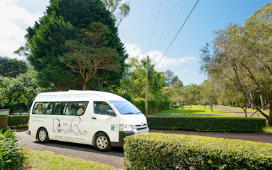 Winery tour bus on a scenic road, Gold Coast pick-up location.