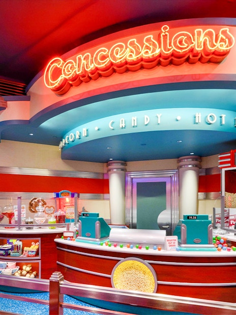 Concession stand at Disneyland Park, California offering popcorn, candy, and hot dogs.
