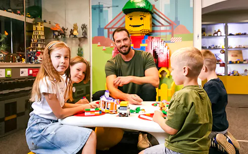 Children building with bricks at Museum of Bricks, interactive play area.