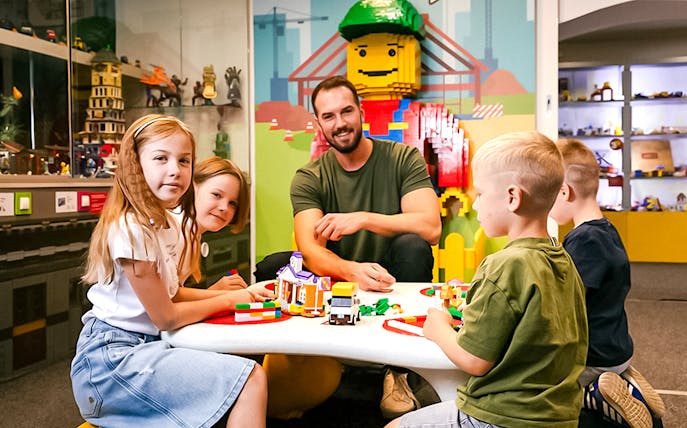Children building with bricks at Museum of Bricks, interactive play area.