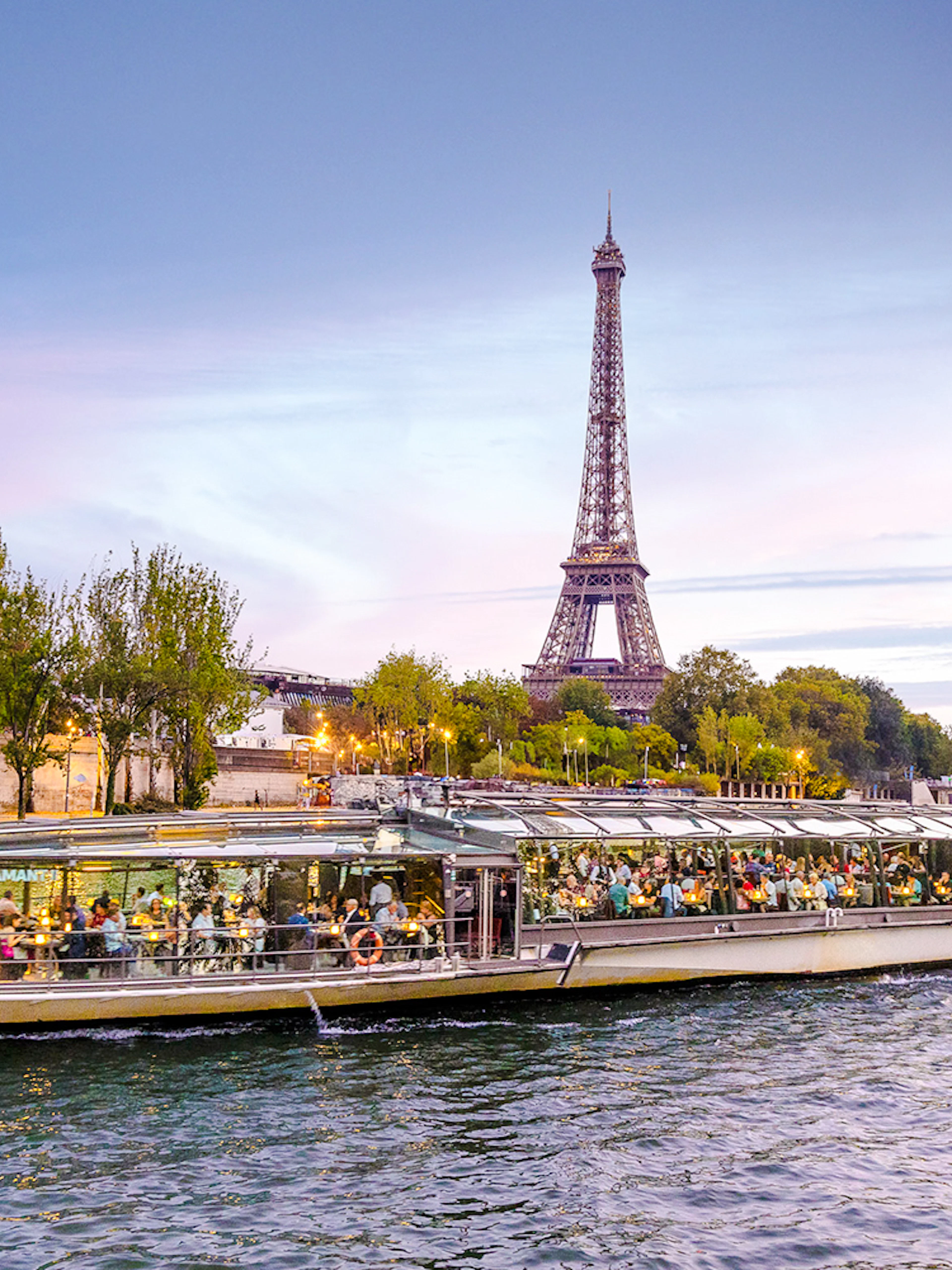 Seine River cruise boat with Eiffel Tower in the background, Paris.
