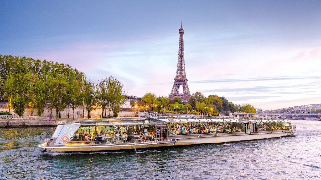 Seine River cruise boat with Eiffel Tower in the background, Paris.