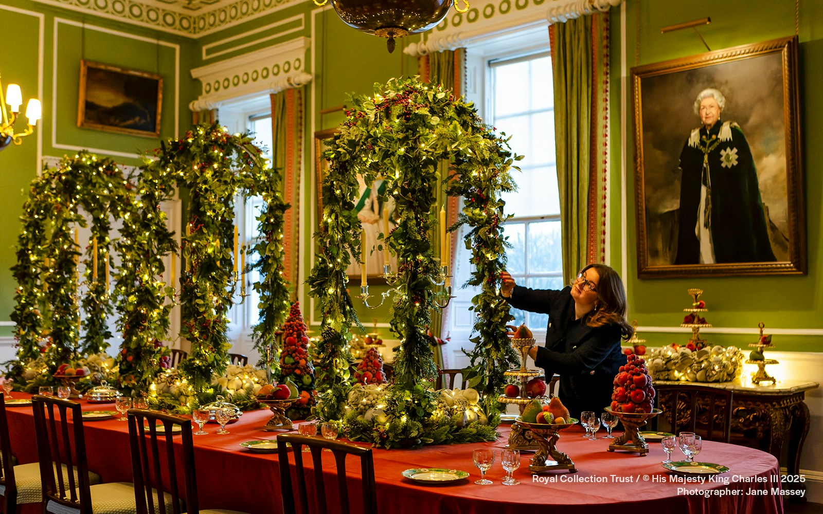 Palace of Holyroodhouse dining room decorated with Christmas garlands and festive table settings.