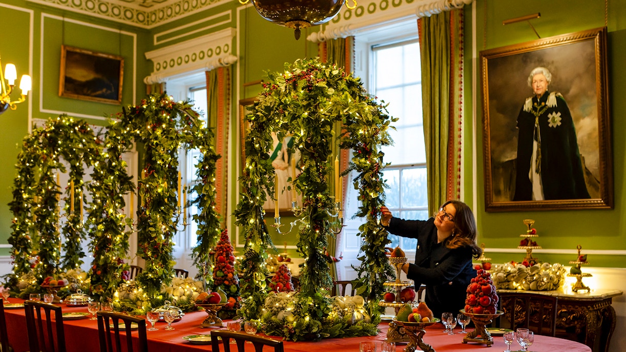Palace of Holyroodhouse dining room decorated with Christmas garlands and festive table settings.