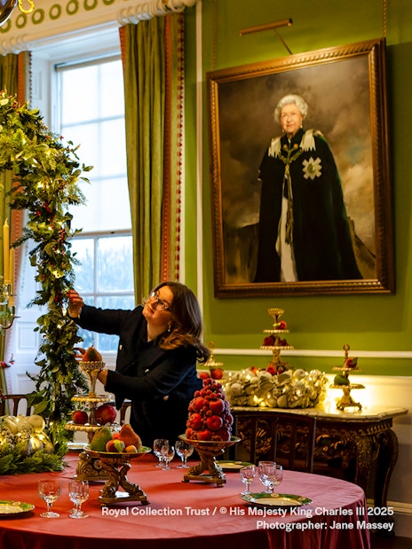 Palace of Holyroodhouse dining room decorated with Christmas garlands and festive table settings.