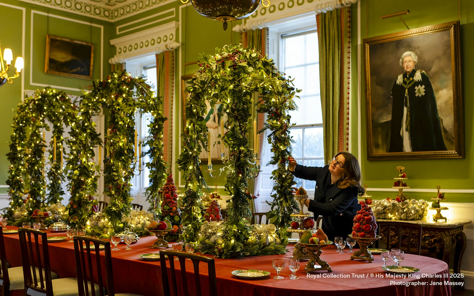 Palace of Holyroodhouse dining room decorated with Christmas garlands and festive table settings.