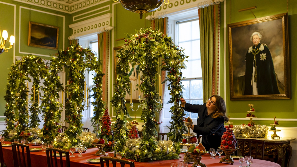 Palace of Holyroodhouse dining room decorated with Christmas garlands and festive table settings.
