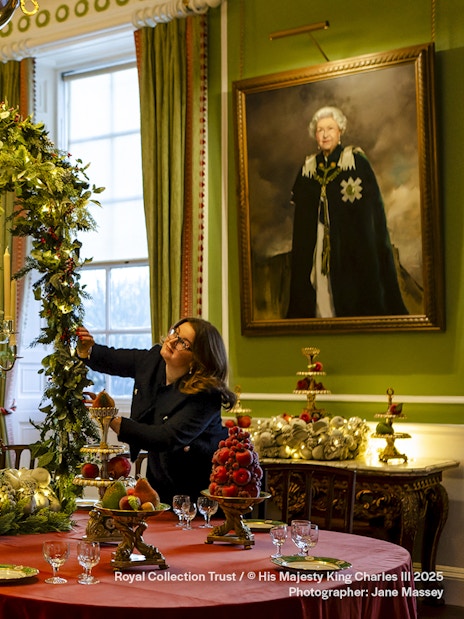 Palace of Holyroodhouse dining room decorated with Christmas garlands and festive table settings.