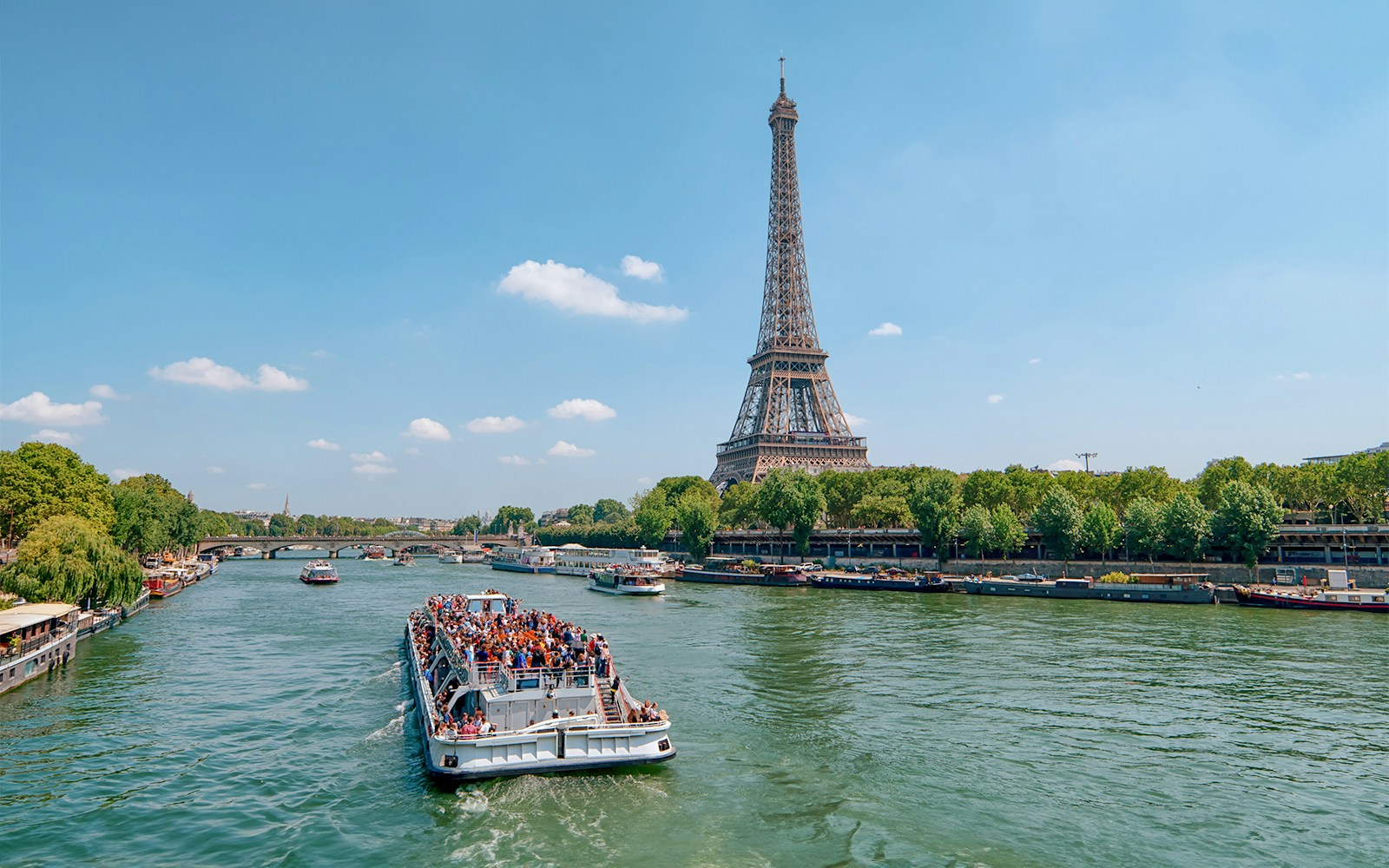 Seine River cruise in Paris with passengers enjoying a French breakfast.