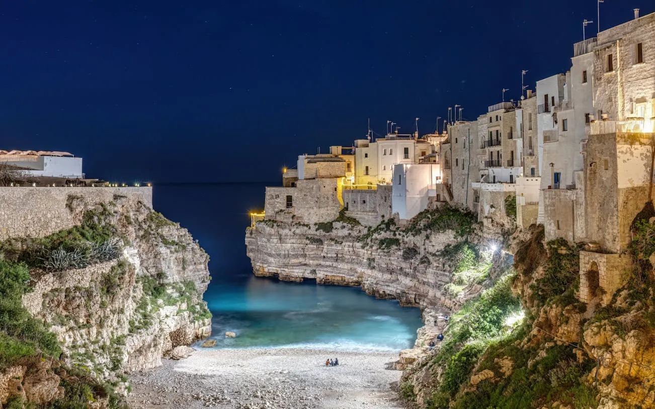 Polignano a Mare cliffside view at night, Valle d'Itria tour from Bari.