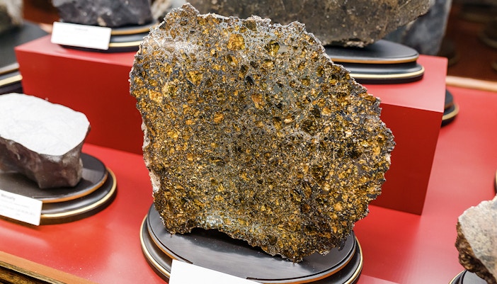 Meteorite specimen displayed in a museum collection exhibit.