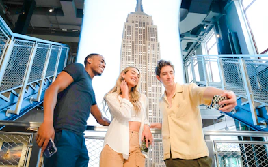 Guests taking a selfie at the Empire State Building observation deck, New York City.