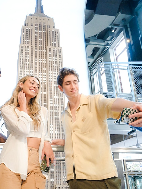 Guests taking a selfie at the Empire State Building observation deck, New York City.