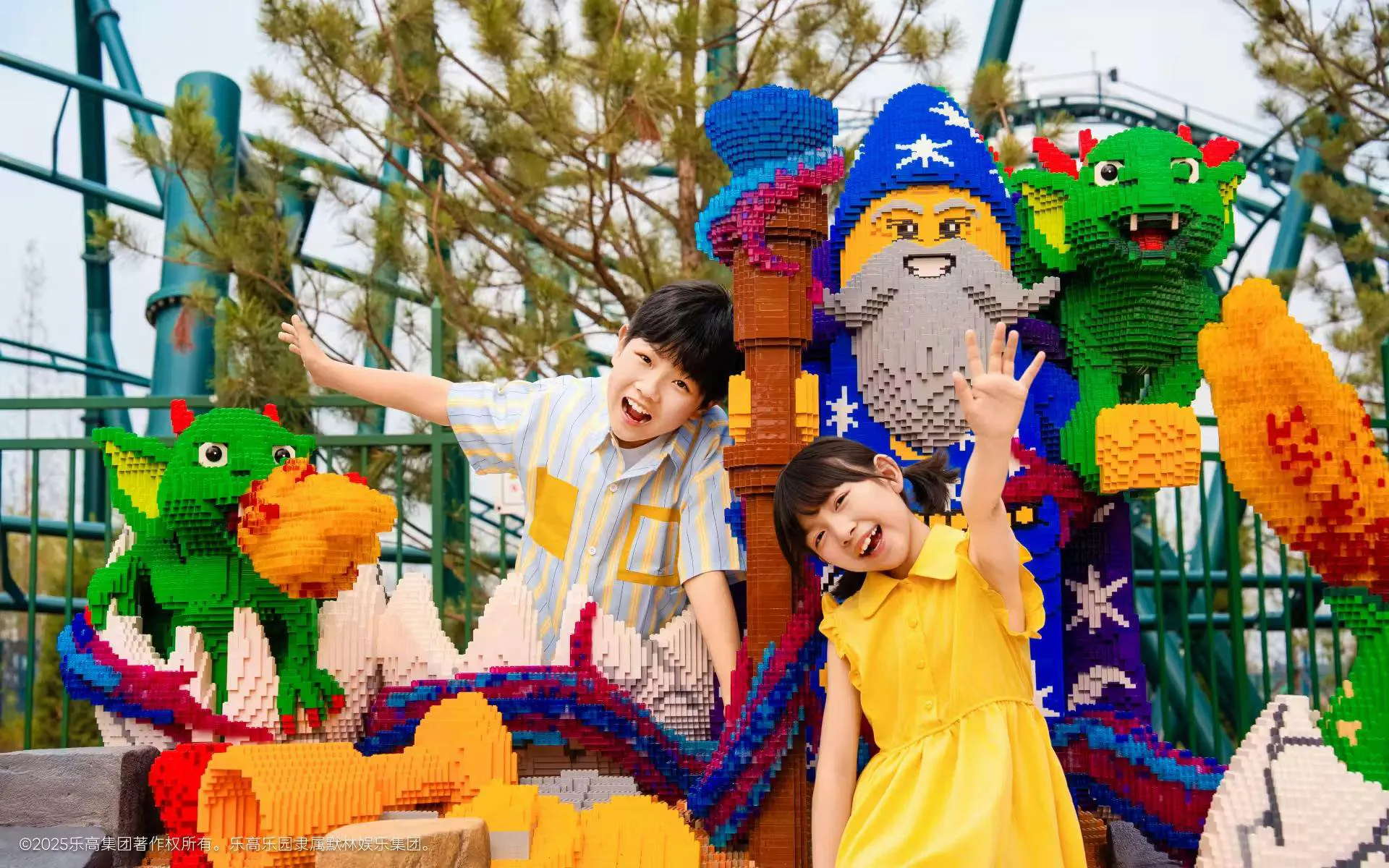 Visitors posing with LEGO dragon and wizard models at LEGOLAND Shanghai Resort.