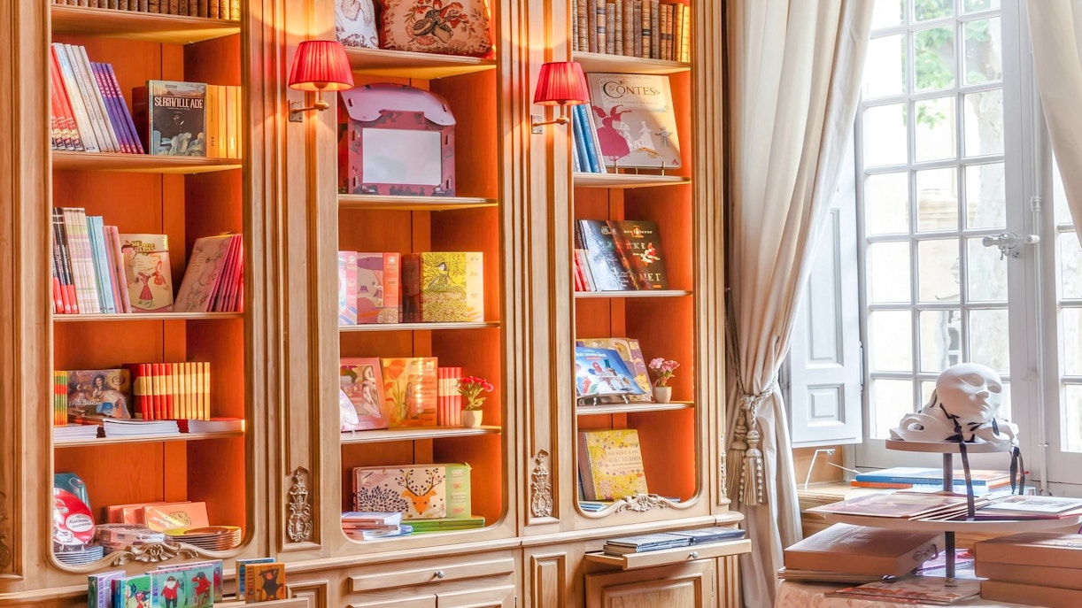 Bookshelves with art books and decor at Caumont Centre d’Art, Aix-en-Provence.