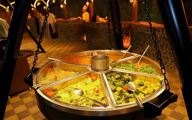 Buffet spread with various dishes at a Dubai desert safari dinner.
