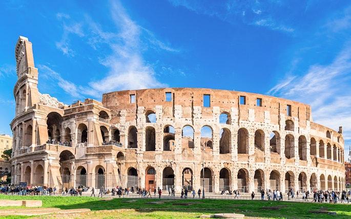 Colosseum exterior with tourists, part of the Palatine Hill & Roman Forum guided tour in Rome.