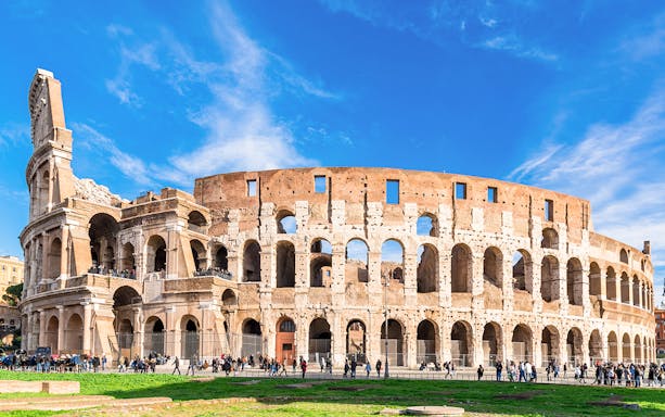 Colosseum exterior with tourists, part of the Palatine Hill & Roman Forum guided tour in Rome.