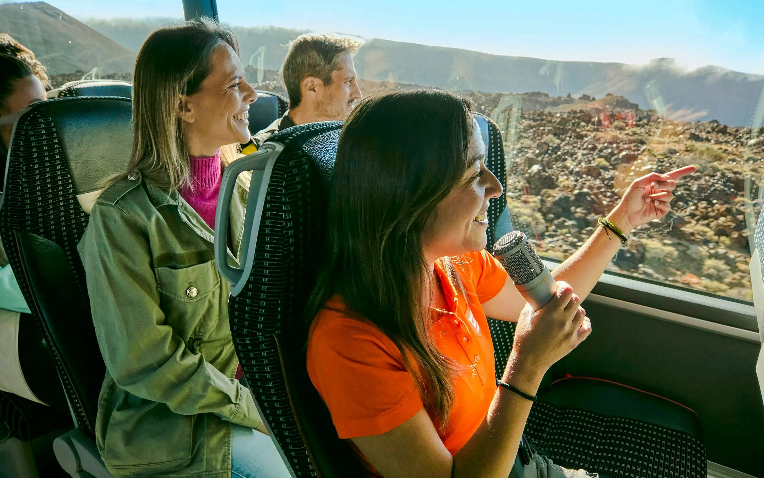 Guests enjoying a guided coach tour on Mount Teide with scenic views outside the window.