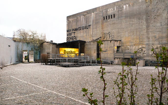 Berlin Story Bunker exterior with entrance and graffiti on concrete walls.