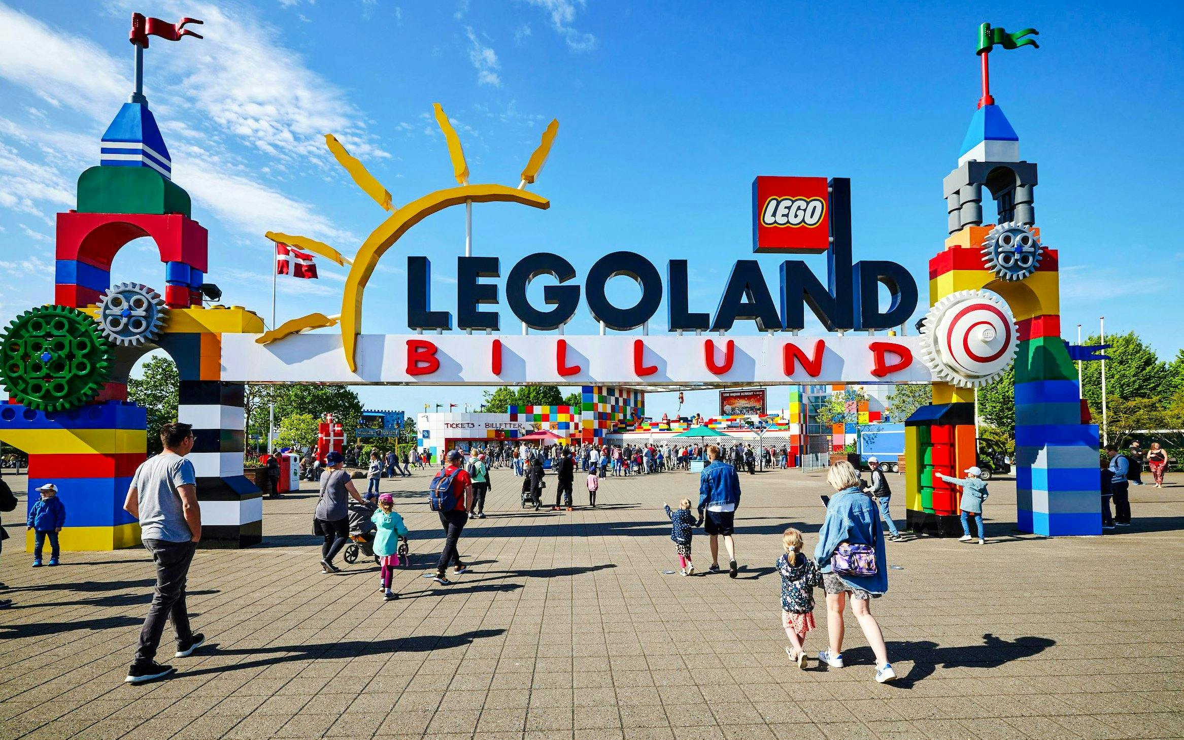 Entrance to LEGOLAND Billund with families entering the park.