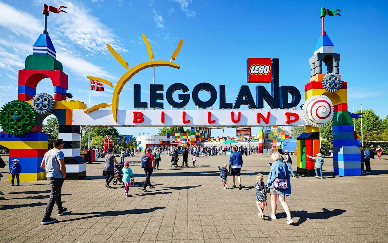 Entrance to LEGOLAND Billund with families entering the park.