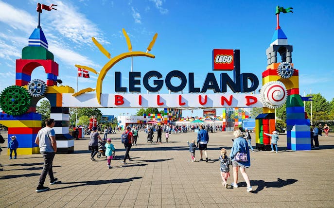 Entrance to LEGOLAND Billund with families entering the park.