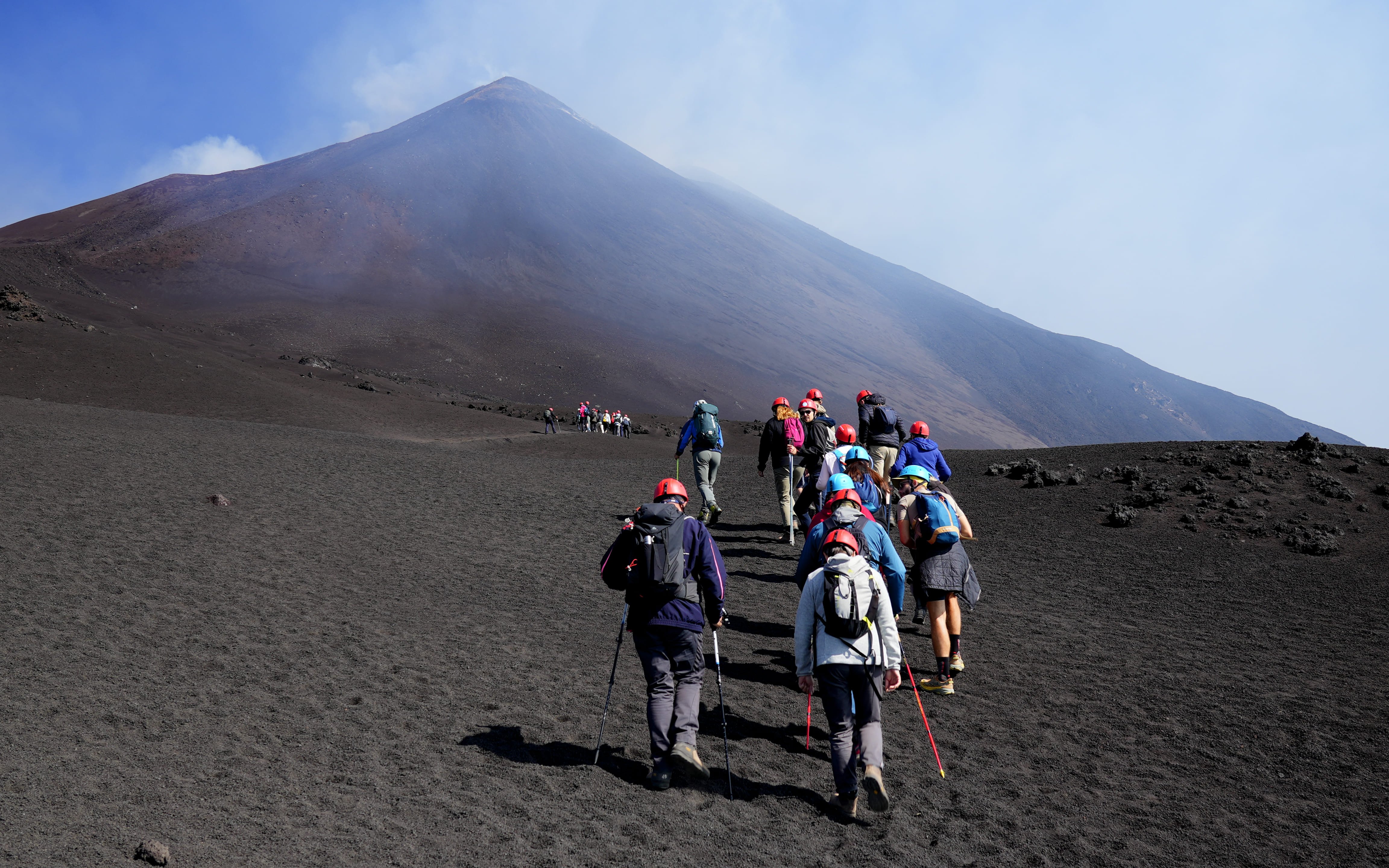Hikers ascending Mount Etna during a guided summit hike.