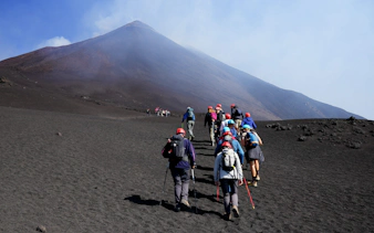 Hikers ascending Mount Etna during a guided summit hike.
