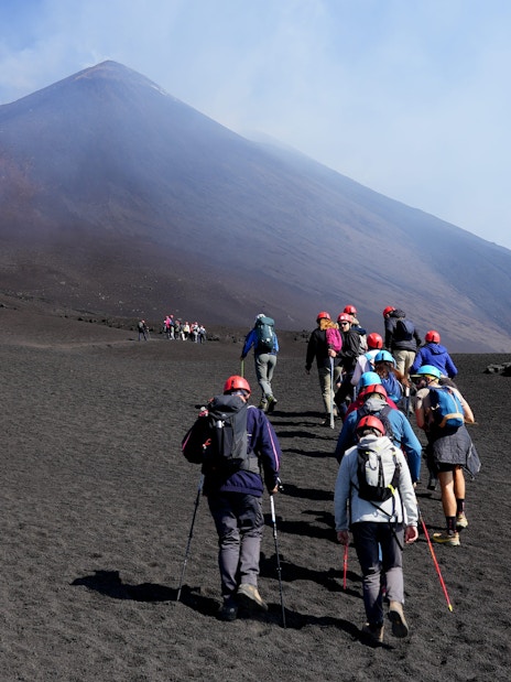 Hikers ascending Mount Etna during a guided summit hike.