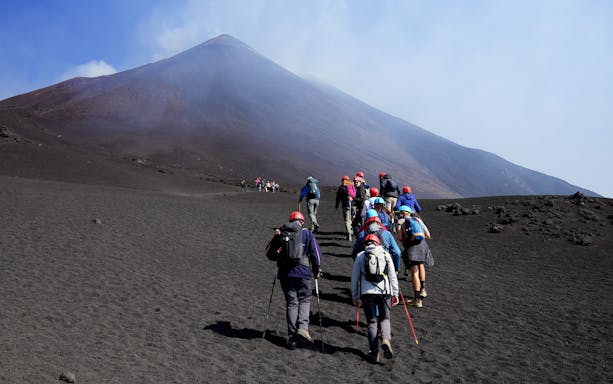 Hikers ascending Mount Etna during a guided summit hike.