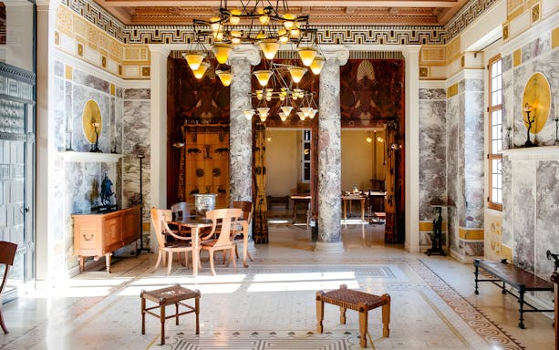 Villa Kerylos interior with marble columns and decorative Greek motifs.