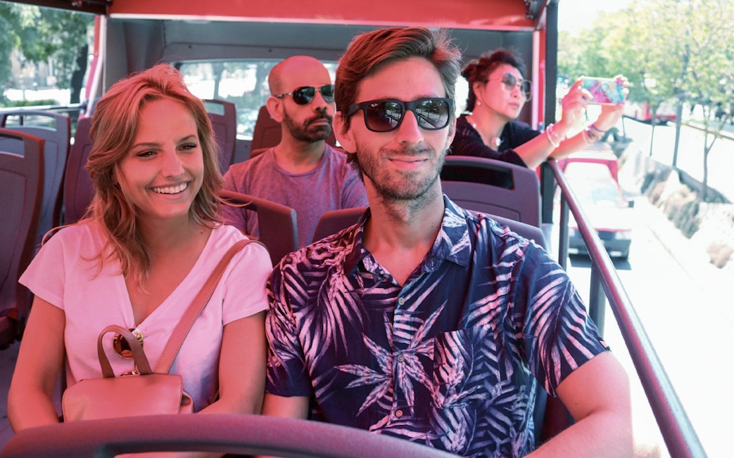 Couple enjoying a Buenos Aires hop-on hop-off tour bus ride.