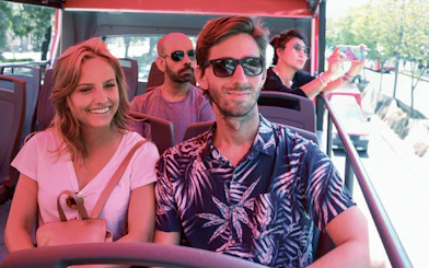Couple enjoying a Buenos Aires hop-on hop-off tour bus ride.