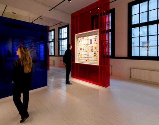 Visitors viewing modern art installation in Amsterdam gallery.