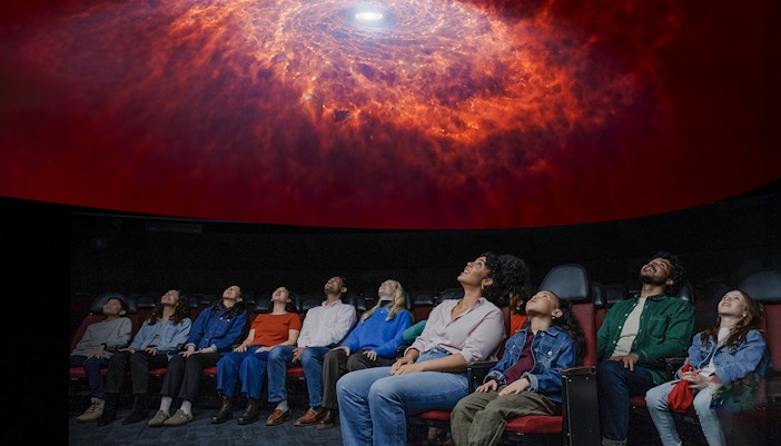Visitors exploring the Encounters in the Milky Way exhibit at the American Museum of Natural History.