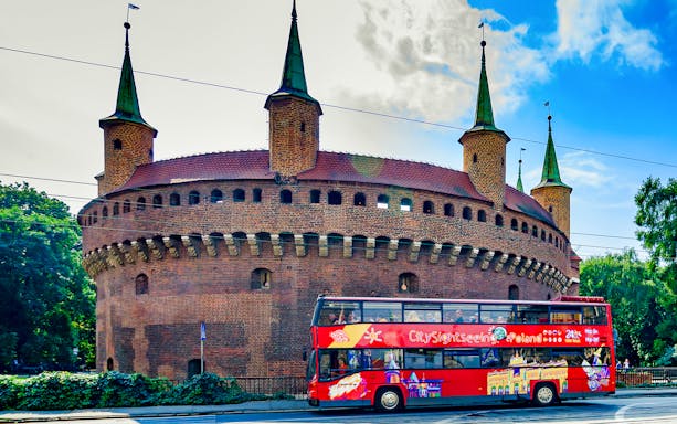 Krakow hop-on hop-off bus in front of the historic Barbican.