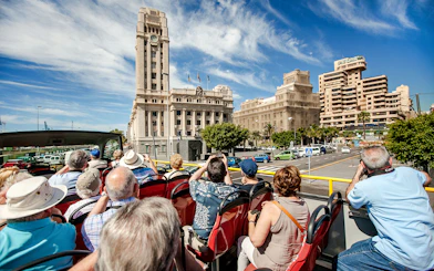 Open-top bus tour in Santa Cruz in front of Palacio Insular de Tenerife.