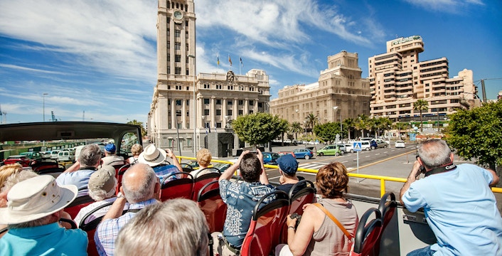 Open-top bus tour in Santa Cruz in front of Palacio Insular de Tenerife.