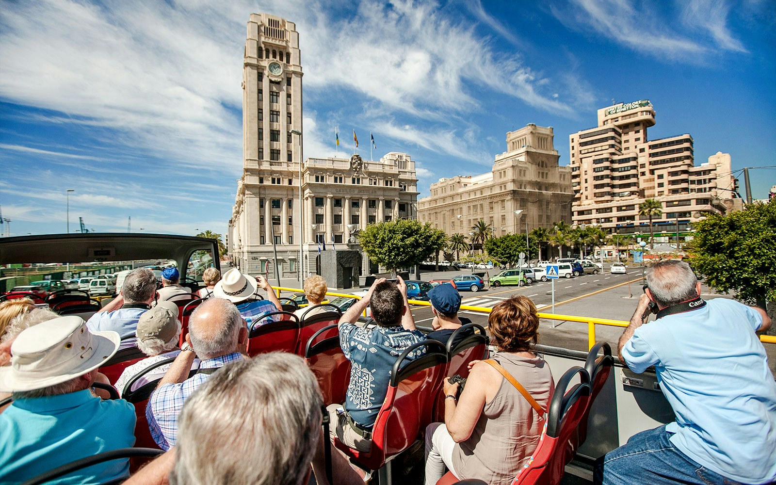 Open-top bus tour in Santa Cruz in front of Palacio Insular de Tenerife.