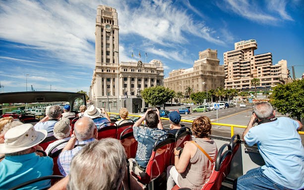 Open-top bus tour in Santa Cruz in front of Palacio Insular de Tenerife.