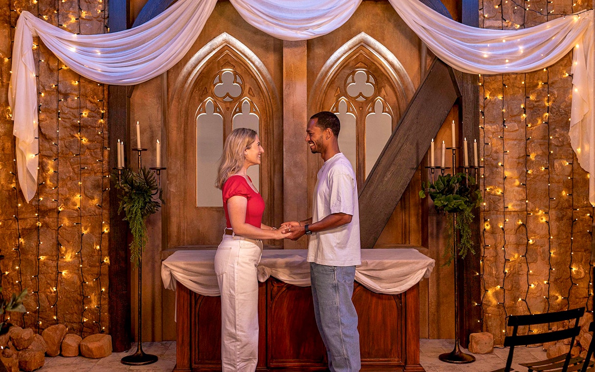 Couple holding hands at The FRIENDS™ Experience set in London.