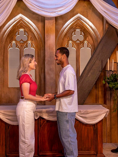 Couple holding hands at The FRIENDS™ Experience set in London.