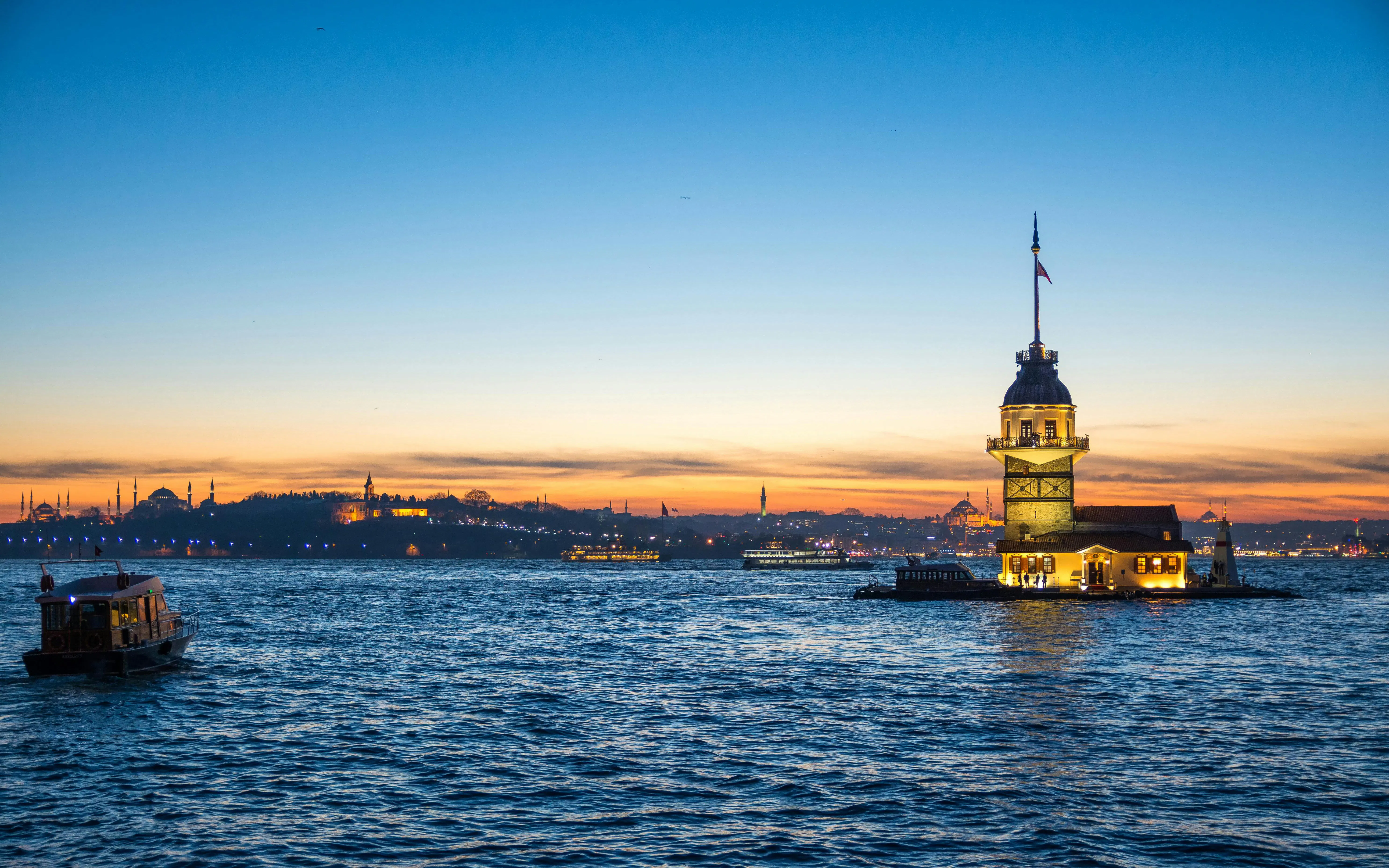 Sundown view of Istanbul skyline with Maiden's Tower and Bosphorus, Turkey.